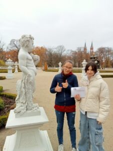 
Dwie wychowanki stoją przy rzeźbie przedstawiającej małego chłopca.
